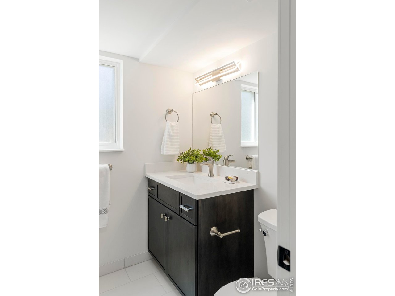 4223 Peach Way Boulder, CO 80301 - Photo 34 of 40 a bathroom with a sink a mirror and a toilet