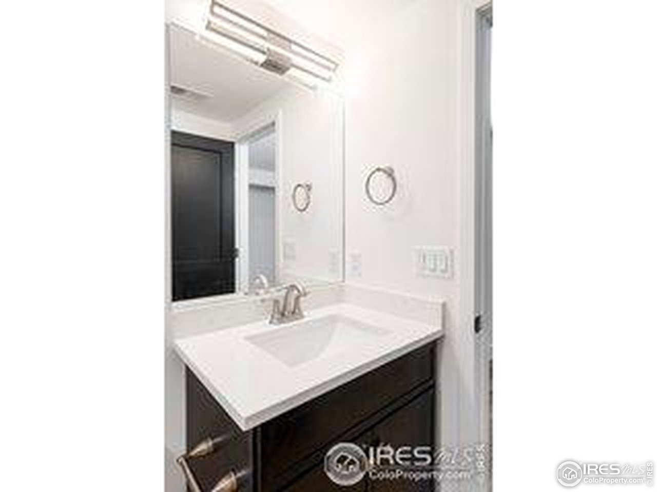 4223 Peach Way Boulder, CO 80301 - Photo 36 of 40 a bathroom with a sink a mirror and a vanity