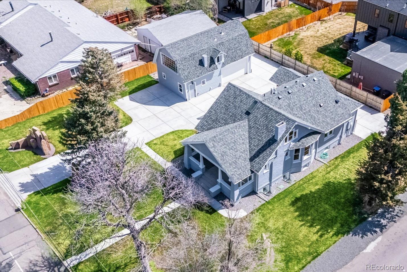 an aerial view of a house with a big yard and large trees