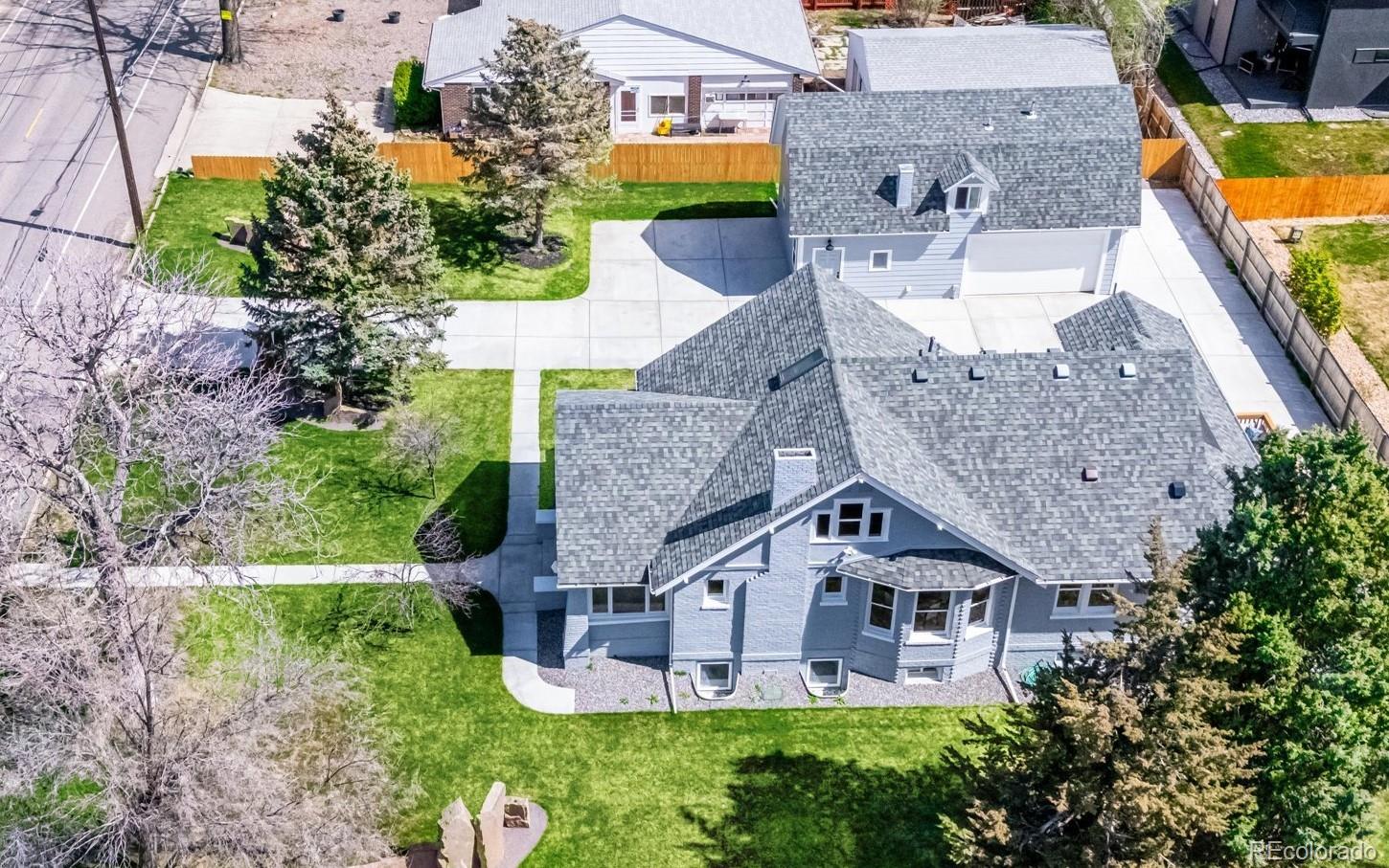 7198 West 29th Avenue Wheat Ridge, CO 80033 - Photo 2 of 49 an aerial view of a house with a big yard and large trees
