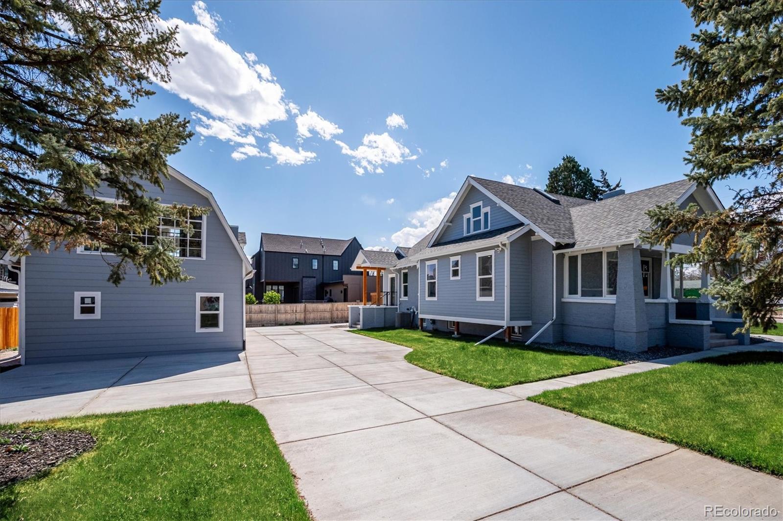 7198 West 29th Avenue Wheat Ridge, CO 80033 - Photo 48 of 49 a front view of a house with a yard and garage
