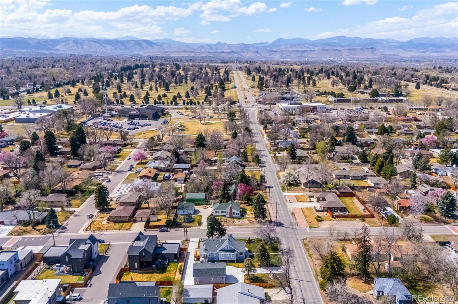 7198 West 29th Avenue Wheat Ridge, CO 80033 - Photo 49 of 49 an aerial view of a city with lots of residential buildings and mountain view in back