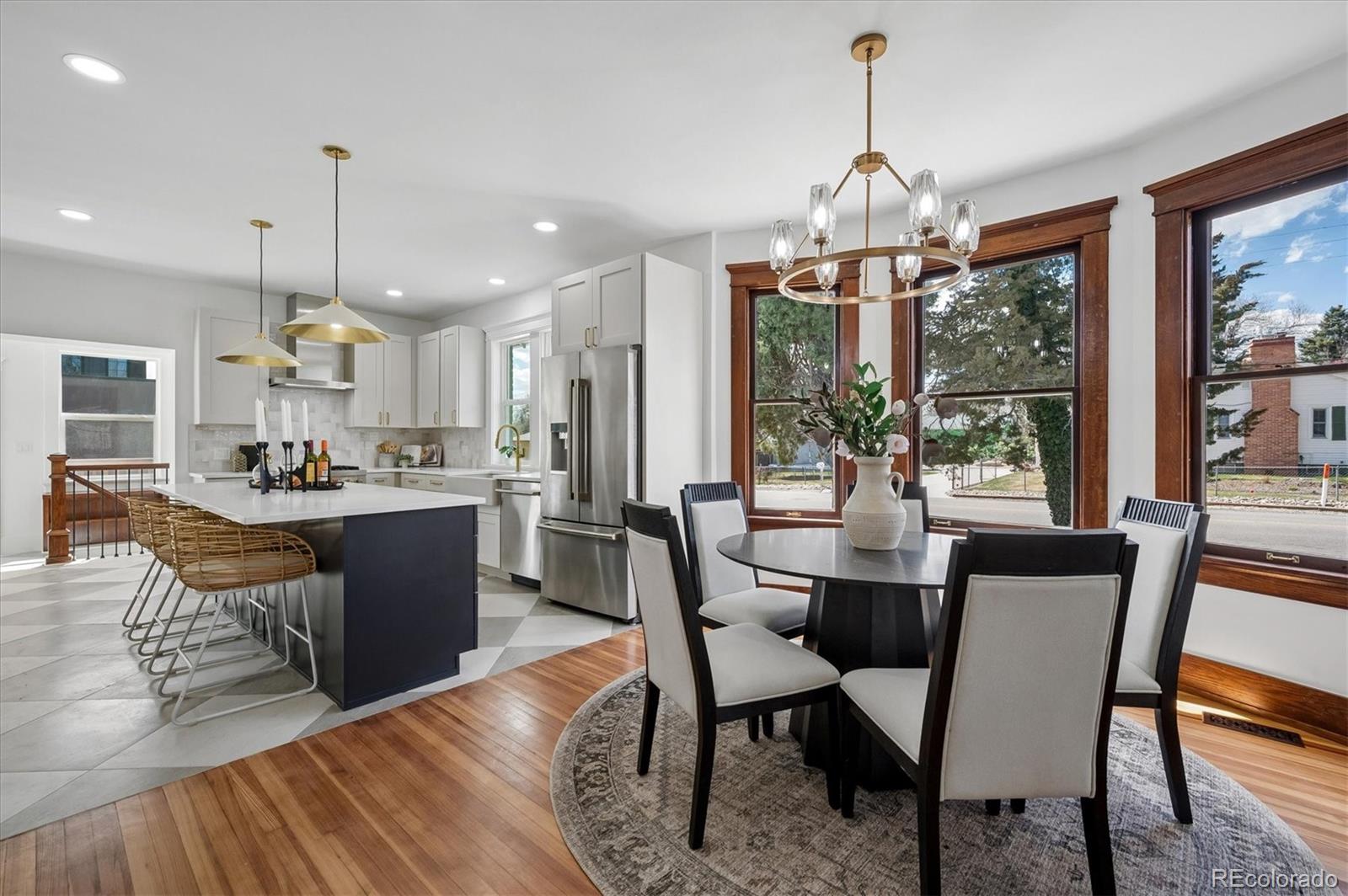 7198 West 29th Avenue Wheat Ridge, CO 80033 - Photo 8 of 49 a dining room filled with furniture a chandelier and wooden floor