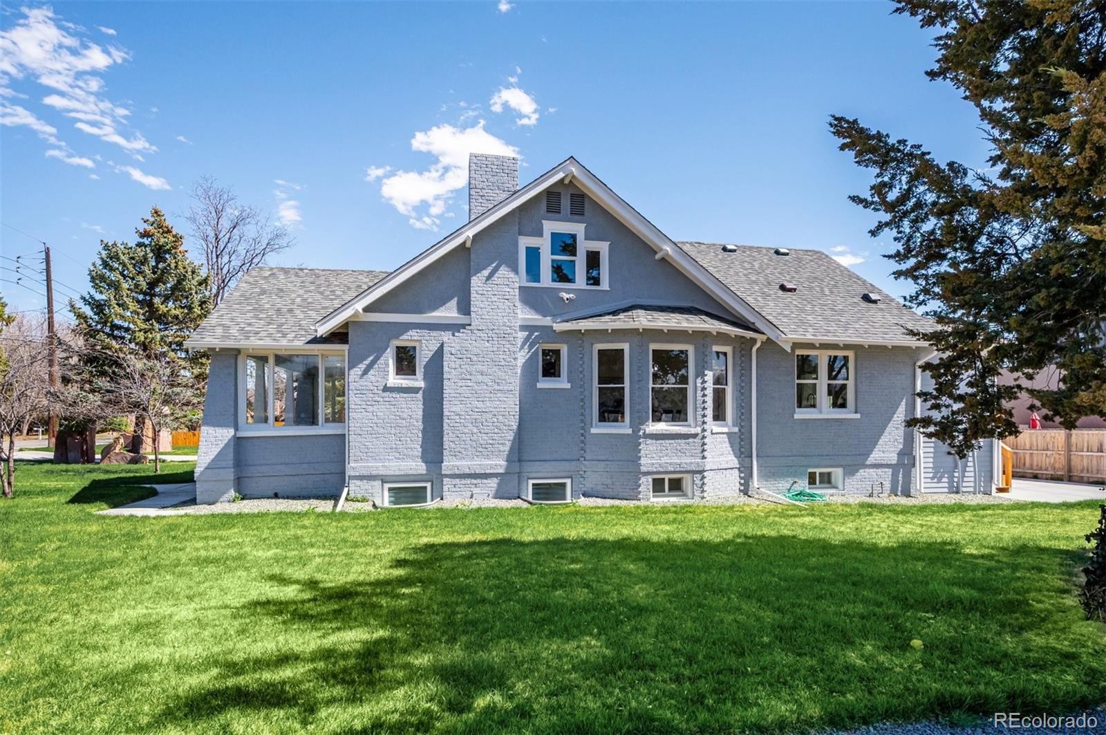 7198 West 29th Avenue Wheat Ridge, CO 80033 - Photo 10 of 49 a front view of house with yard and green space