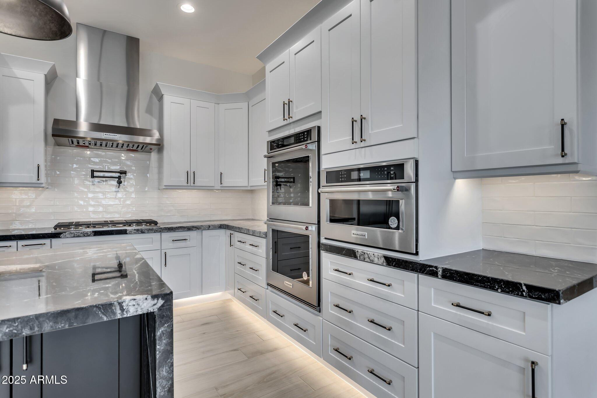 1602 East Cloud Road Phoenix, AZ 85086 - Photo 11 of 45 a kitchen with granite countertop white cabinets and stainless steel appliances
