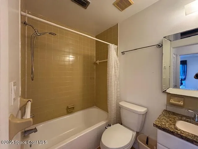 a white toilet sitting next to a bath tub