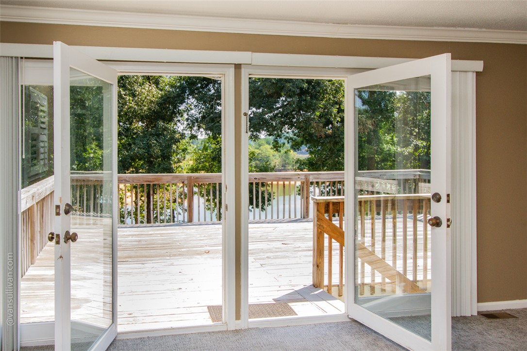 4518 Cove Trail Anderson, SC 29621 - Photo 21 of 49 Double French doors open to a spacious wooden deck overlooking the peaceful waters of Lake Hartwell.
