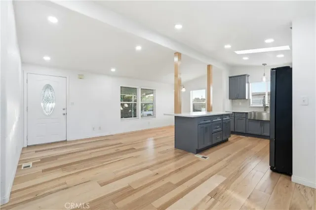 a room with a couch and a view of kitchen