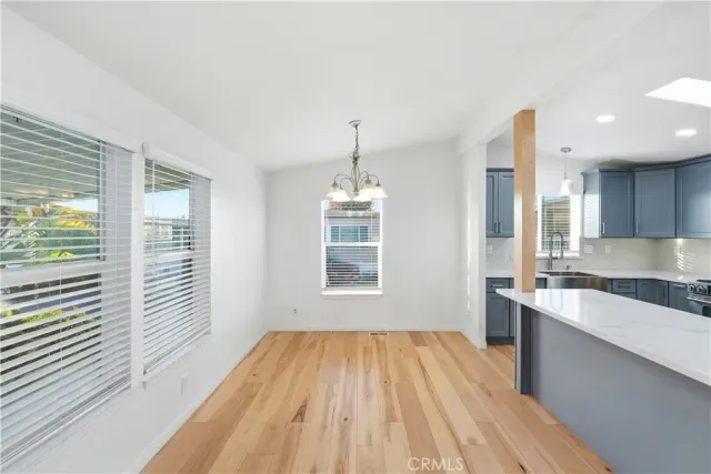 a view of a kitchen with wooden floor and windows