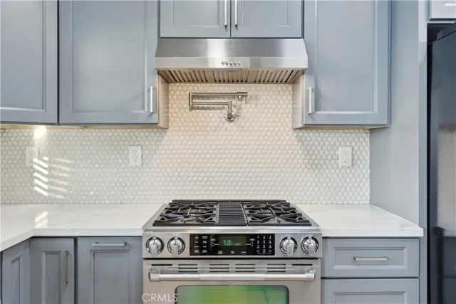 a stove top oven sitting inside of a kitchen