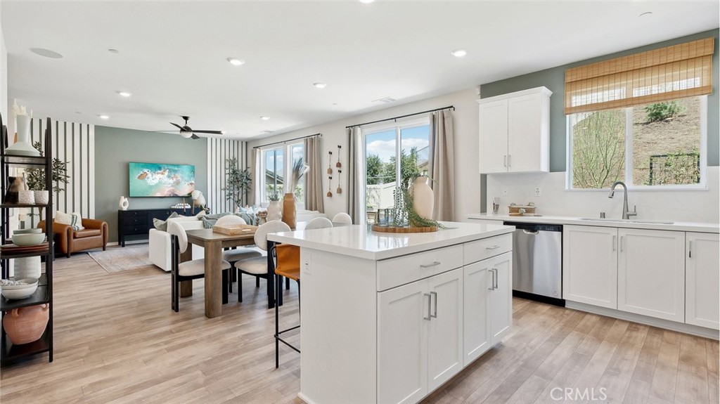 11392 Forge Road Corona, CA 92883 - Photo 6 of 24 a kitchen with white cabinets and sink