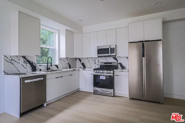 a kitchen with a refrigerator stove and microwave
