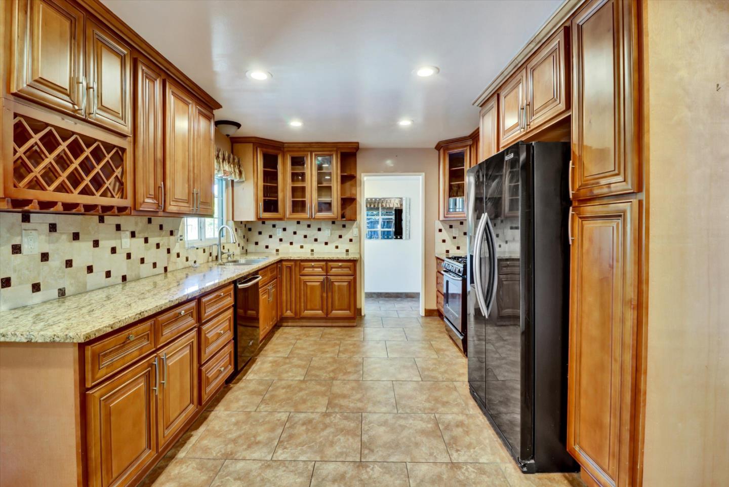 331 David Avenue Campbell, CA 95008 - Photo 6 of 32 a large kitchen with stainless steel appliances granite countertop a refrigerator and a sink