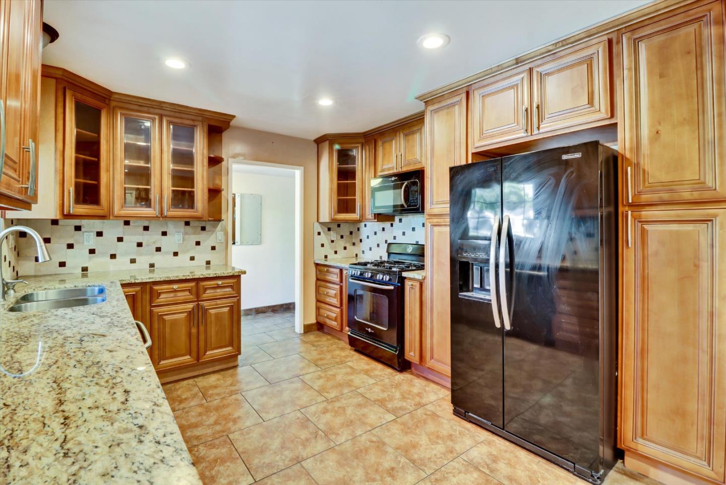 331 David Avenue Campbell, CA 95008 - Photo 7 of 32 a kitchen with stainless steel appliances granite countertop a refrigerator a stove and wooden cabinets