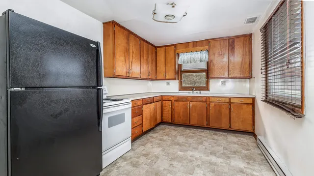 a kitchen with stainless steel appliances granite countertop a refrigerator and a sink