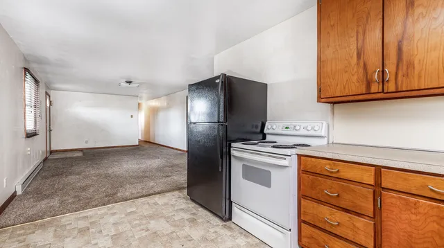 a kitchen with stainless steel appliances granite countertop a refrigerator and a stove top oven