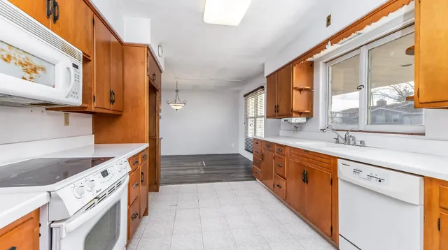 a kitchen with stainless steel appliances granite countertop a sink and a stove
