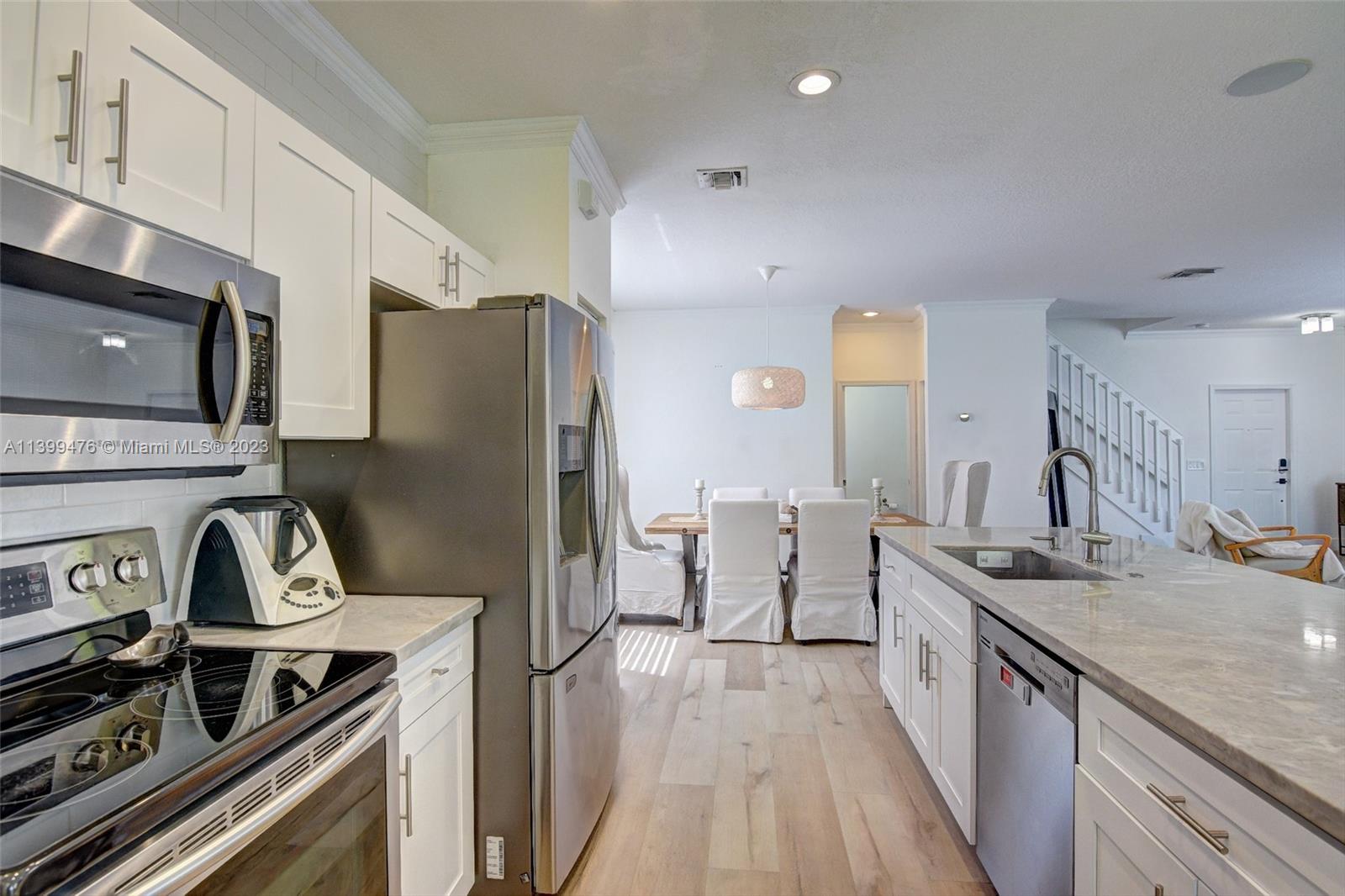 471 Fishtail Terrace Weston, FL 33327 - Photo 11 of 33 a kitchen with stainless steel appliances a stove a sink dishwasher a refrigerator and a stove