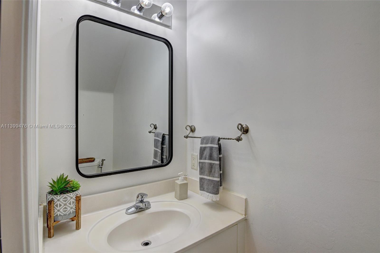 471 Fishtail Terrace Weston, FL 33327 - Photo 14 of 33 a bathroom with a sink and a mirror