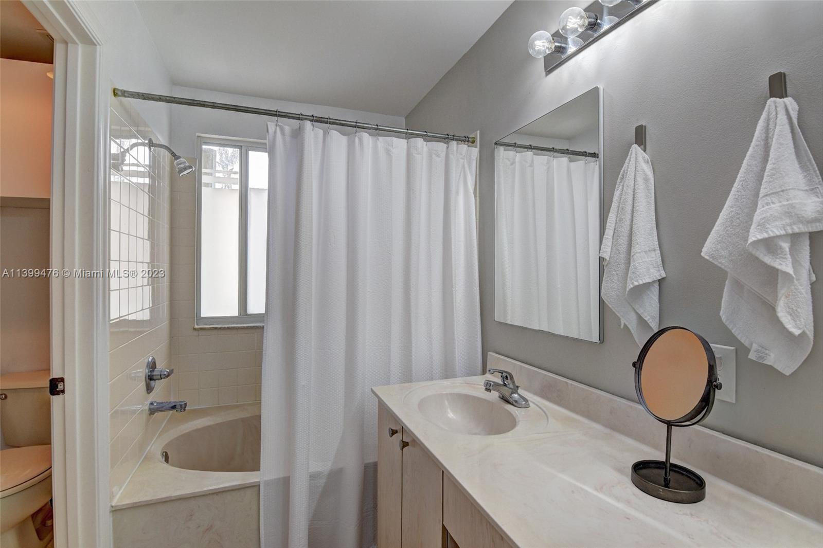 471 Fishtail Terrace Weston, FL 33327 - Photo 18 of 33 a bathroom with a sink tub and mirror