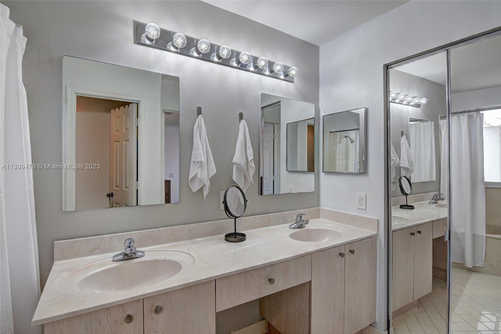 471 Fishtail Terrace Weston, FL 33327 - Photo 19 of 33 a bathroom with double vanity sinks a vanity a mirror and shower