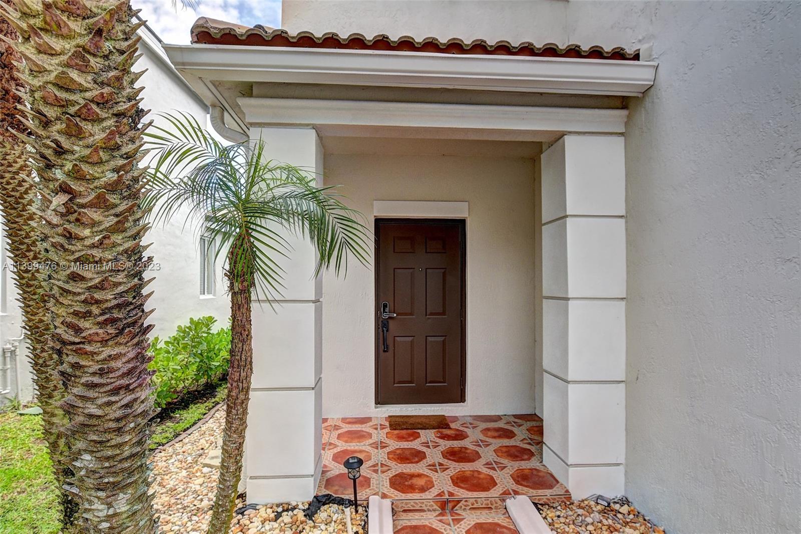 471 Fishtail Terrace Weston, FL 33327 - Photo 2 of 33 a bedroom with a bed and a potted plant