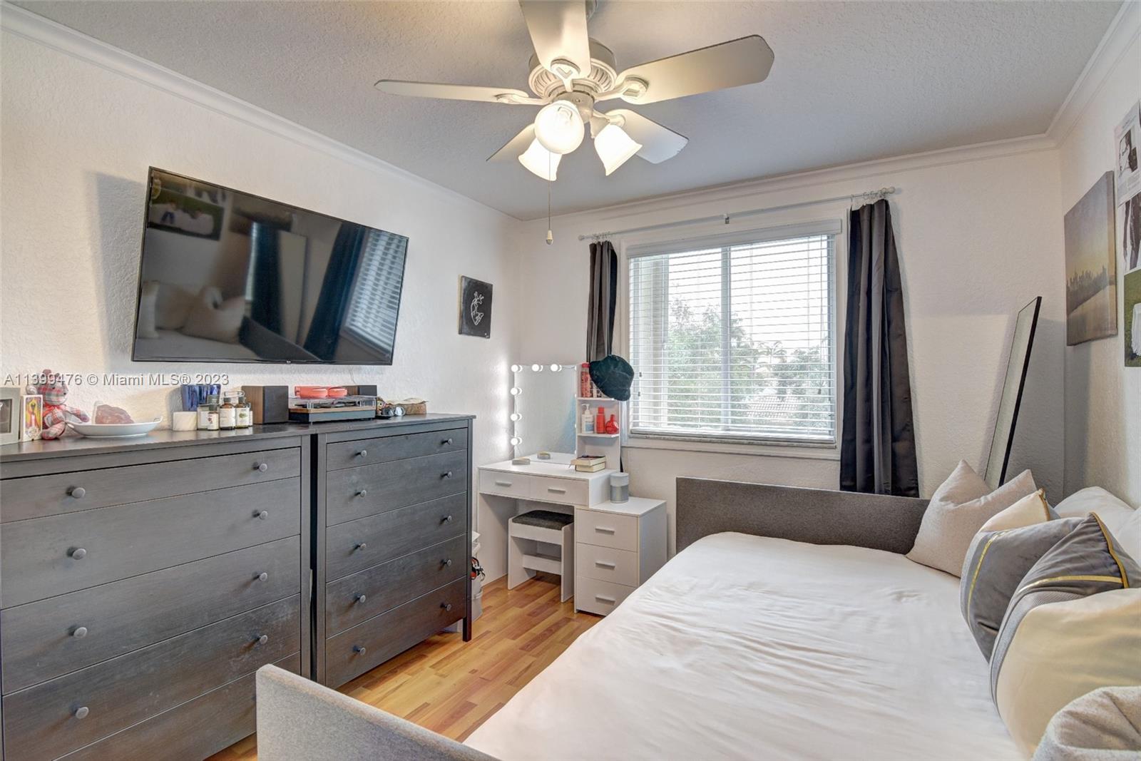 471 Fishtail Terrace Weston, FL 33327 - Photo 22 of 33 a bedroom with a bed and a flat screen tv