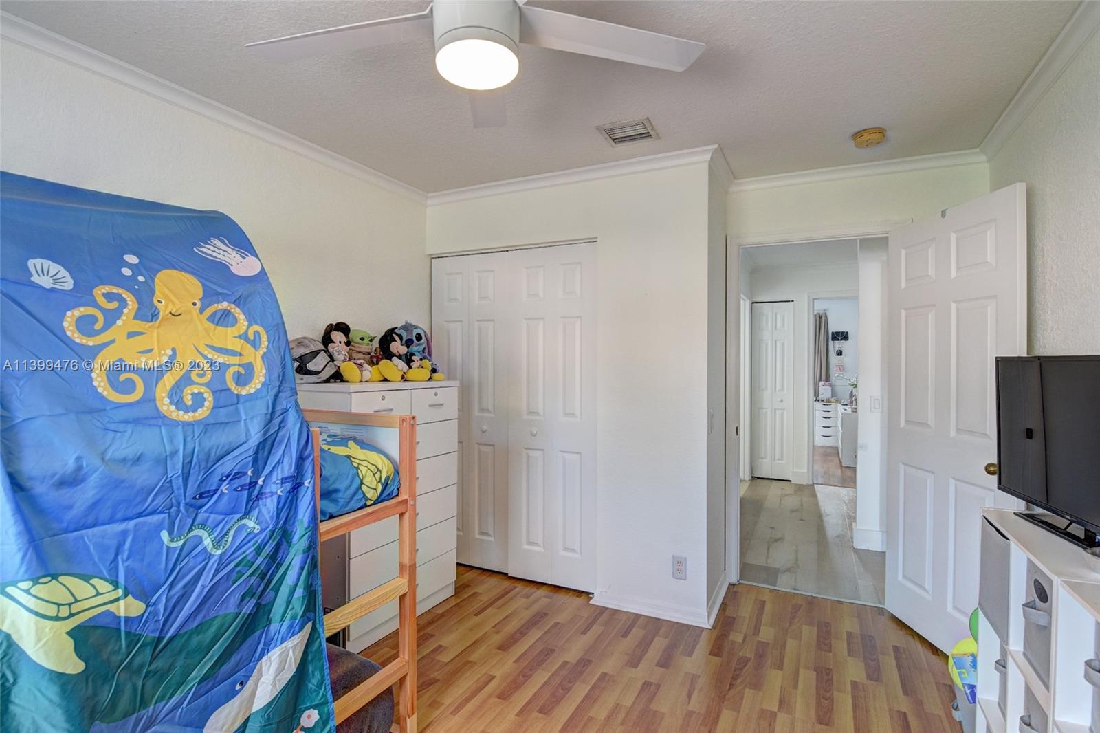 471 Fishtail Terrace Weston, FL 33327 - Photo 26 of 33 a bedroom with a bed and a flat tv screen on the dresser