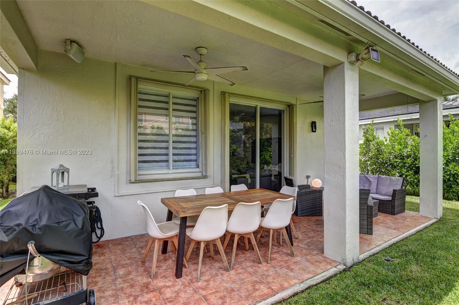 471 Fishtail Terrace Weston, FL 33327 - Photo 28 of 33 a view of a patio with table and chairs
