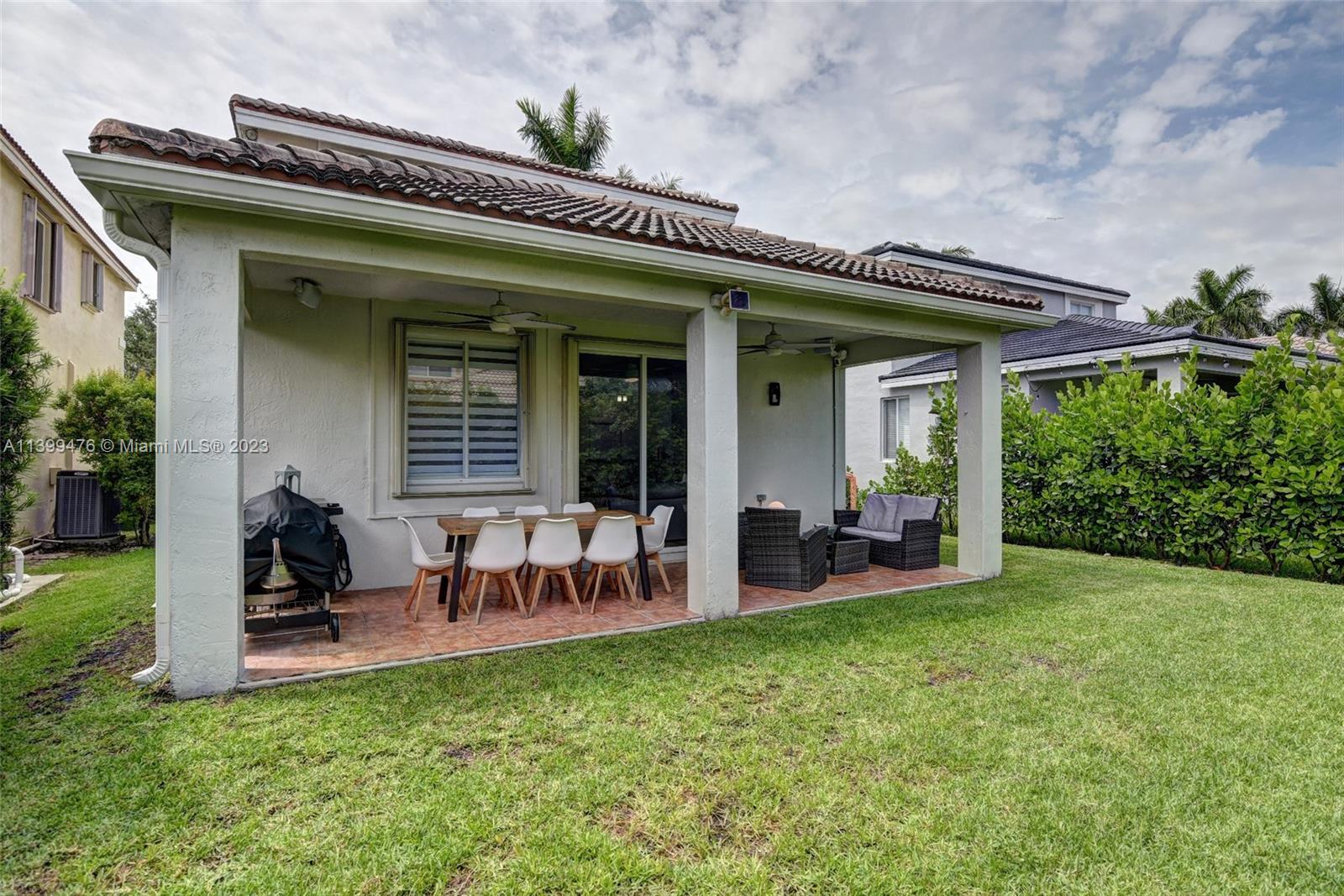 471 Fishtail Terrace Weston, FL 33327 - Photo 31 of 33 a view of a chair and table in backyard of the house