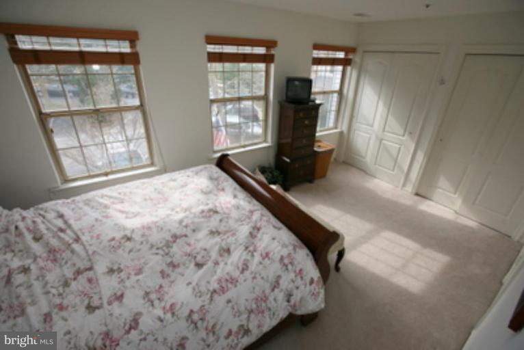 3323 Sea Port Way Silver Spring, MD 20902 - Photo 13 of 29 a bedroom with a bed window and mirror