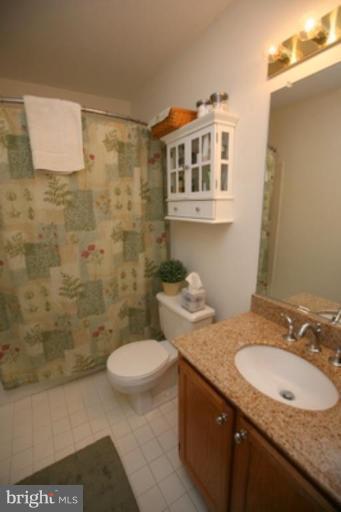 3323 Sea Port Way Silver Spring, MD 20902 - Photo 14 of 29 a bathroom with a granite countertop sink and a mirror