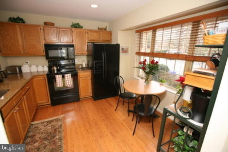 3323 Sea Port Way Silver Spring, MD 20902 - Photo 3 of 29 a kitchen with stainless steel appliances kitchen island granite countertop a refrigerator and a stove top oven
