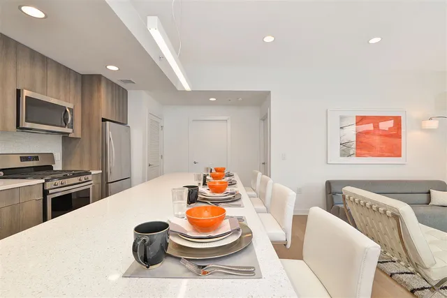 a kitchen with a appliances a sink and a refrigerator