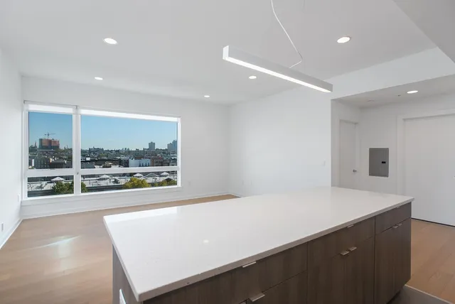 a large white kitchen with a large window