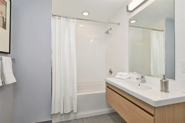 a bathroom with a sink a mirror and a shower