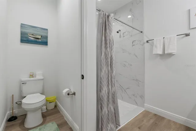 a bathroom with a shower and a toilet