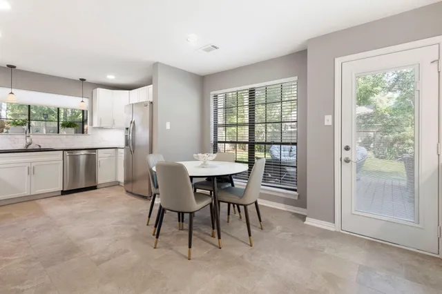 a dining room with furniture and window