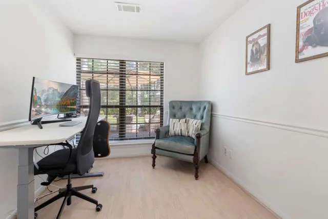 a view of workspace with furniture and window