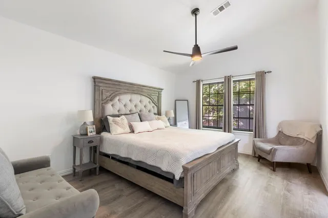 a bedroom with a bed couch and a window