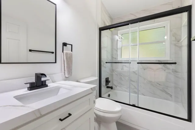 a bathroom with a sink toilet and shower