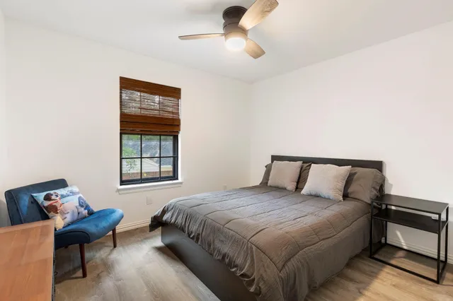 a bed sitting in a bedroom next to a window