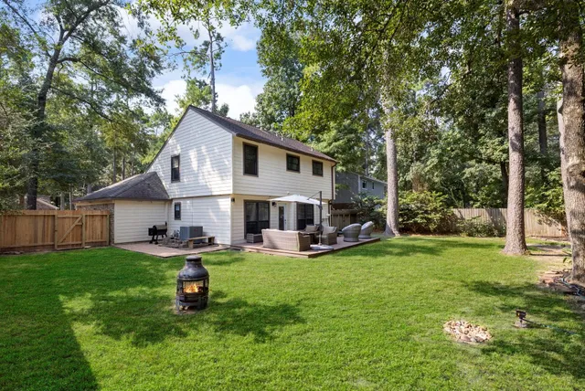 a view of a house with a yard and sitting area