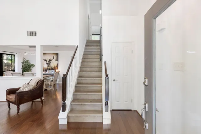 a view of a hallway with wooden floor and entryway