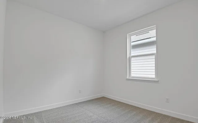 a bathroom with a toilet sink vanity and mirror