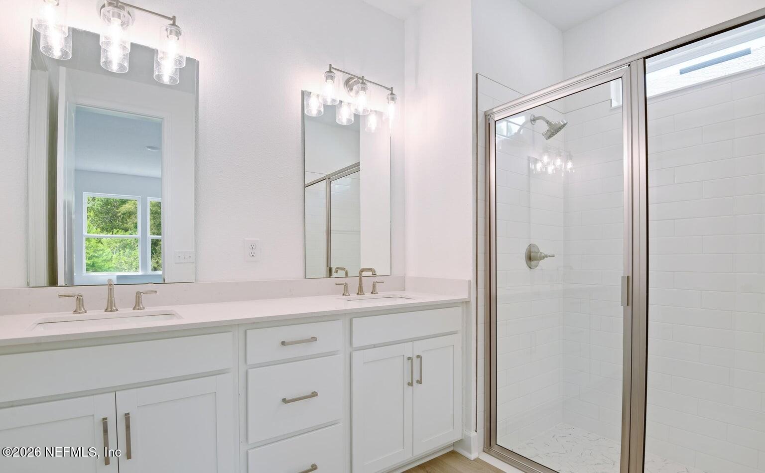 434 Cedar Elm Way St. Augustine, FL 32092 - Photo 16 of 27 a bathroom with a double vanity sink mirror and double