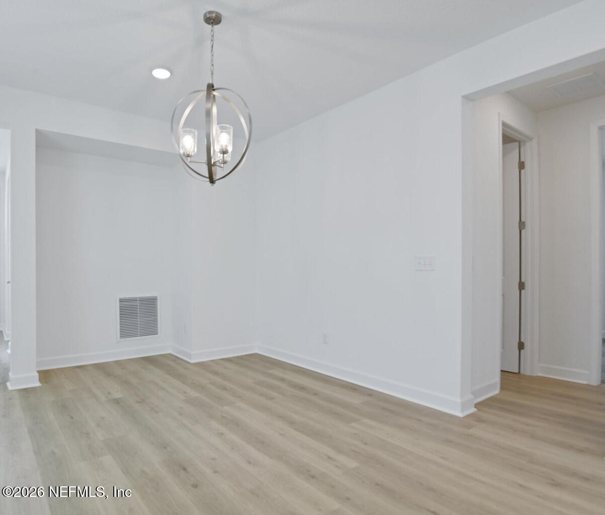 434 Cedar Elm Way St. Augustine, FL 32092 - Photo 9 of 27 a view of empty room with wooden floor