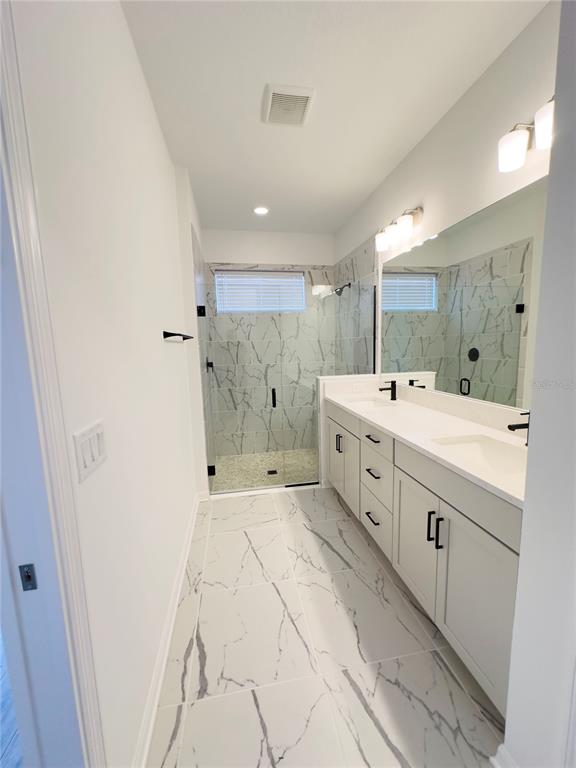 17937 Cherished Loop Lakewood Ranch, FL 34211 - Photo 18 of 30 a large white bathroom with a double vanity sink mirror and