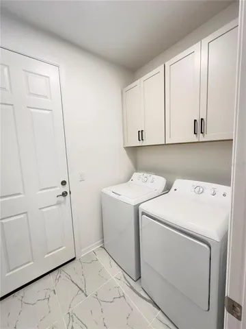 a view of storage and utility room with washer and dryer