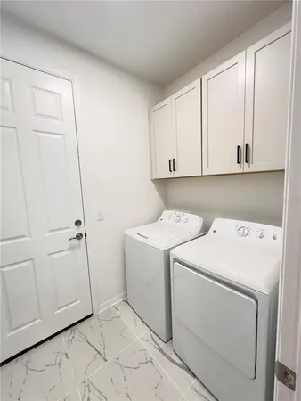 a view of storage and utility room with washer and dryer